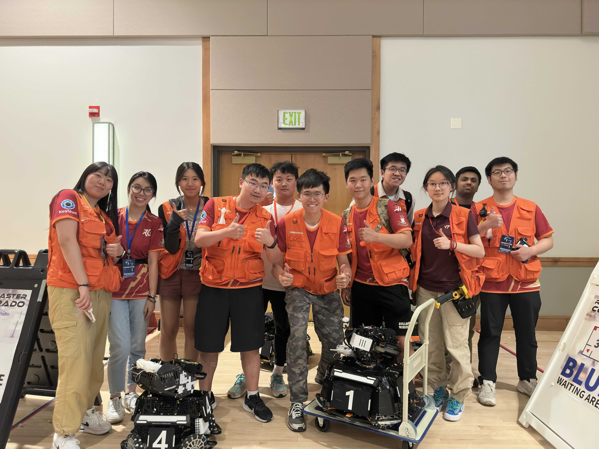 The team together with the robots at the venue